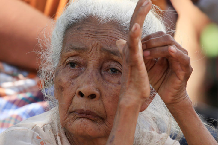 A woman sits at a refugee camp after an earthquake hit Sigar Penjalin village in North Lombok