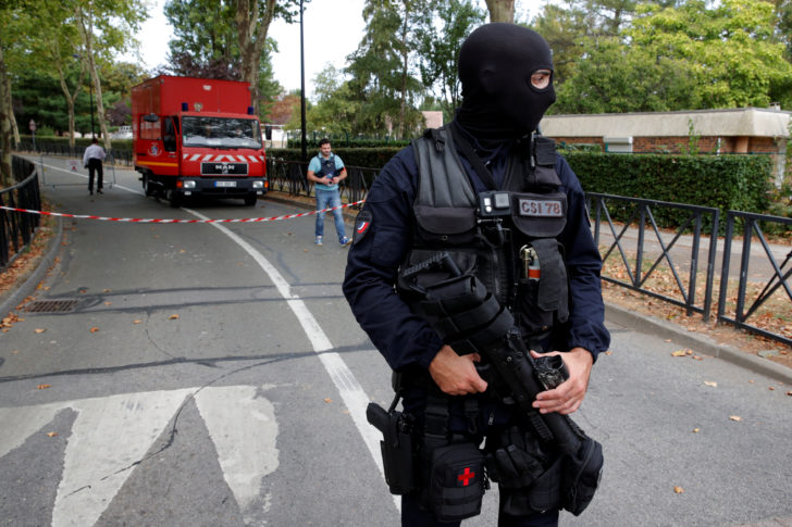 French police secure a street after a man killed two persons and injured an other in a knife attack in Trappes, near Paris