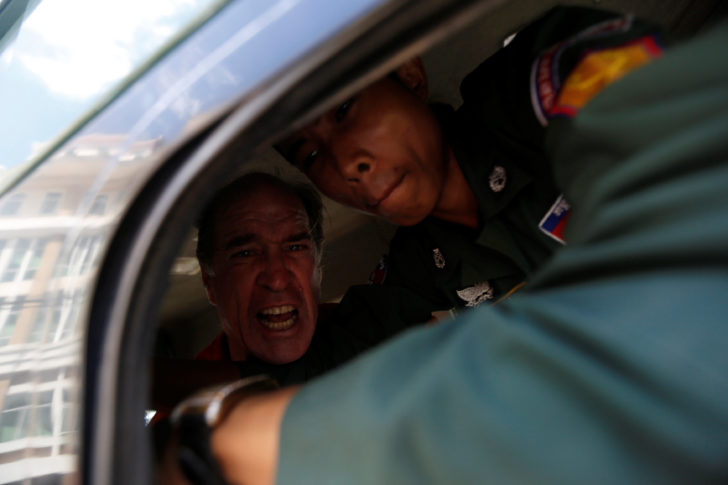 Australian filmmaker James Ricketson shouts inside a prison truck as he leaves the Municipal Court of Phnom Penh