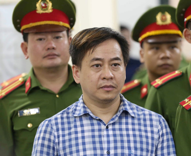 Phan Van Anh Vu (Vu Nhom) listens during the verdict session of his trial at a court in Hanoi