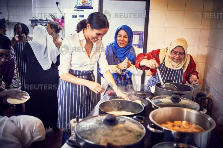 Britain's Meghan, Duchess of Sussex, cooks with women in the Hubb Community Kitchen at the Al Manaar Muslim Cultural Heritage Centre in west London
