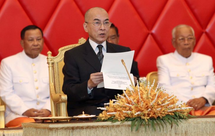 Cambodia's King Norodom Sihamoni reads a document as he attends a senate meeting in Phnom Penh, Cambodia