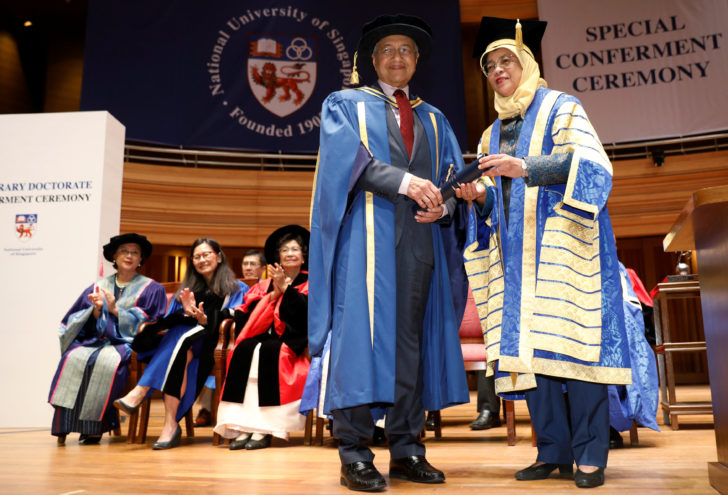 Malaysia's Prime Minister Mahathir Mohamad is conferred an honorary Doctor of Laws degree by Singapore's President Halimah Yacob at the National University of Singapore's Yong Siew Toh Conservatory of Music in Singapore
