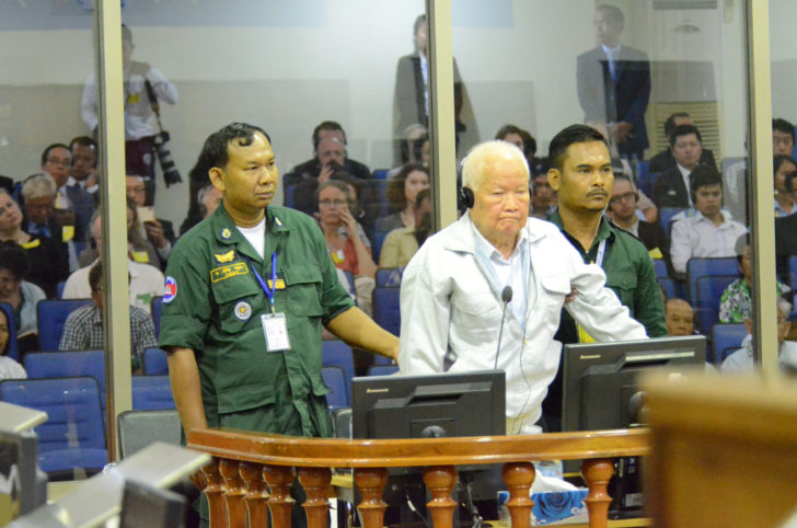 Former Khmer Rouge head of state Khieu Samphan stands inside a dock at the courtroom of the Extraordinary Chambers in the Courts of Cambodia (ECCC) as he awaits a verdict, on the outskirts of Phnom Penh