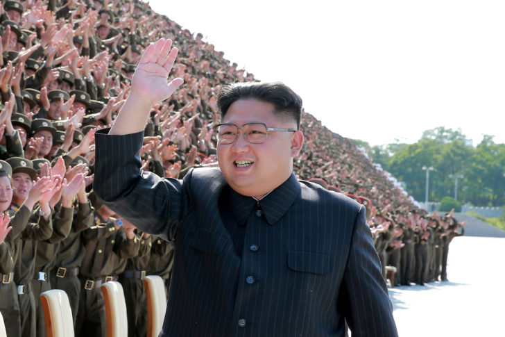FILE PHOTO: North Korean leader Kim Jong Un waves at a photo session with attendants in the fourth Active Secretaries of Primary Organization of KPA Youth