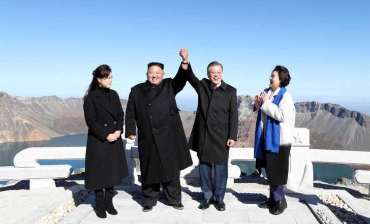 South Korean President Moon Jae-in and North Korean leader Kim Jong Un pose for photographs on the top of Mt. Paektu