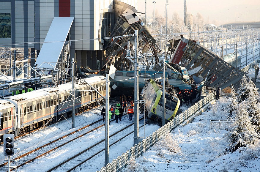 Rescue workers search at the wreckage after a high speed train crash in Ankara