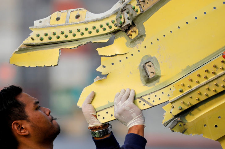 FILE PHOTO: A KNKT official carries debris from the crashed Lion Air flight JT610 at Tanjung Priok port in Jakarta