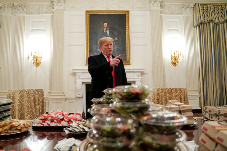 U.S. President Donald Trump speaks in front of fast food provided for the 2018 College Football Playoff National Champion Clemson Tigers due to the partial government shutdown in the State Dining Room of the White House in Washington