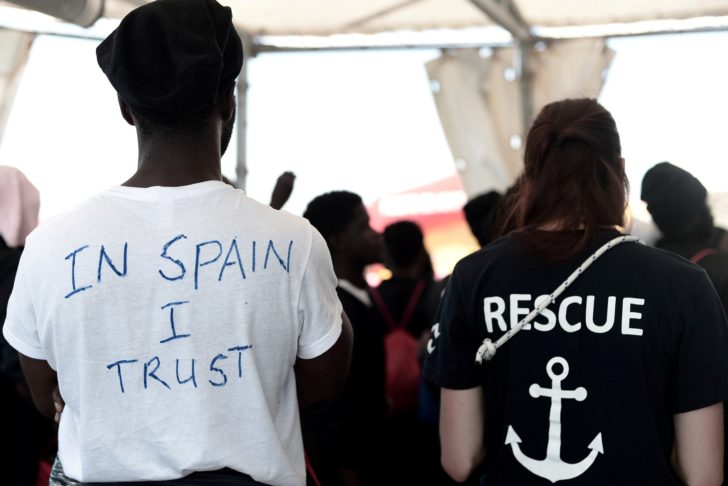 FILE PHOTO: A migrant wearing a t-shirt reading
