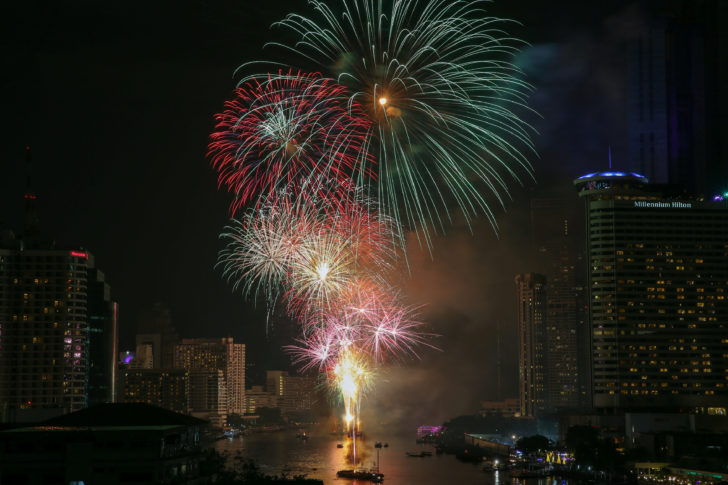 Fireworks explode over Chao Phraya River during New Year's celebrations in Bangkok