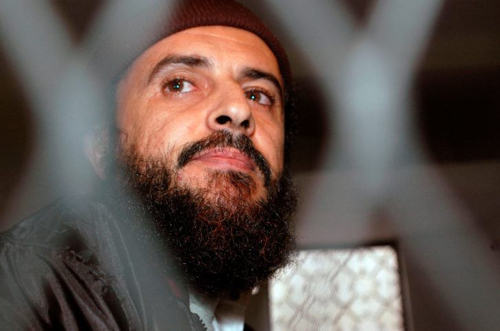 FILE PHOTO: Yemeni Islamic militant Jamal al-Badawi looks from behind bars during the first hearing of a Sana'a court of appeals hearing