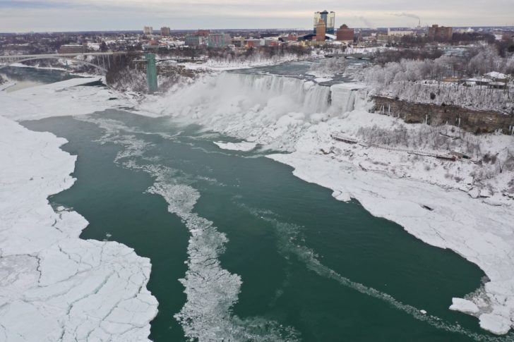 An aerial photo taken over the American side shows water flowing around ice due to subzero temperatures in Niagara Falls
