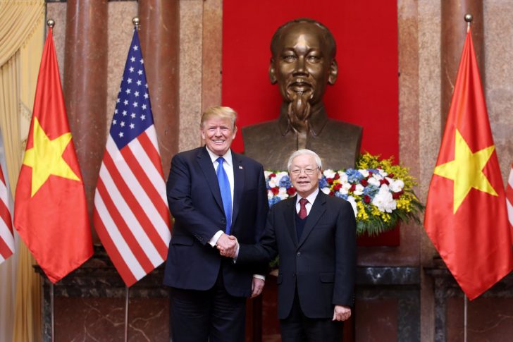 US President Donald J. Trump (L) shakes hands with his Vietnamese counterpart Nguyen Phu Trong (R) at the Presidential Palace in Hanoi