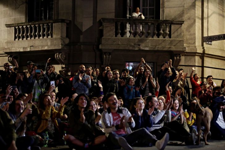 People react after Mexican filmmaker Alfonso Cuaron won the best director Oscar for his film