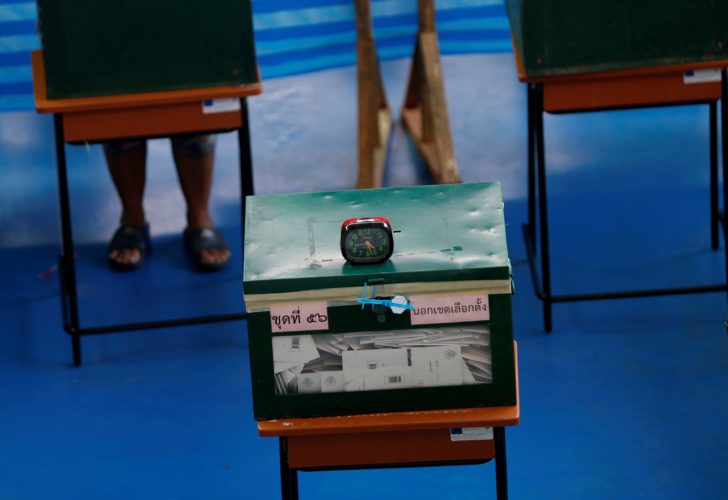 A woman casts her early vote for the upcoming Thai election at a polling station in Bangkok