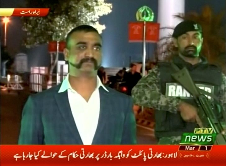 Indian pilot, Wing Commander Abhinandan, stands under armed escort near Pakistan-India border in Wagah