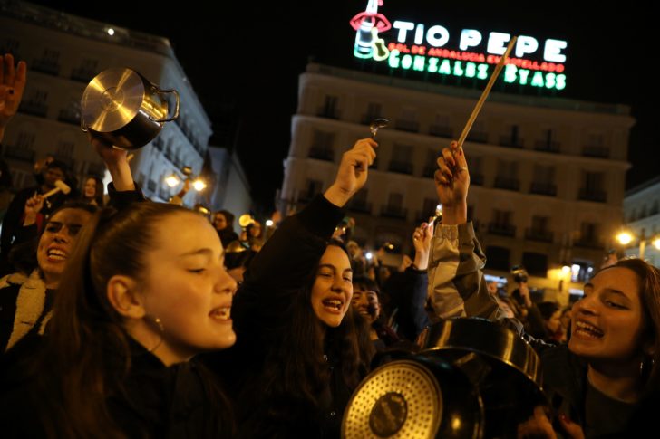 Women bang pots and pans during a protest at the start of a nationwide feminist strike on International Women's Day at Puerta del Sol Square in Madrid