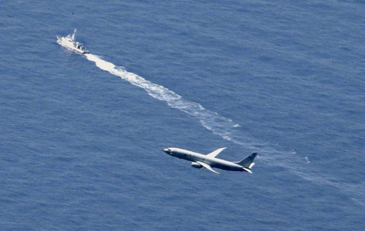 A Japan Coast Guard vessel and a U.S. military aircraft conduct rescue and search operations at the site where an Air Self-Defense Force's F-35A stealth fighter jet crashed during an exercise on April 9, 2019, off Aomori prefecture