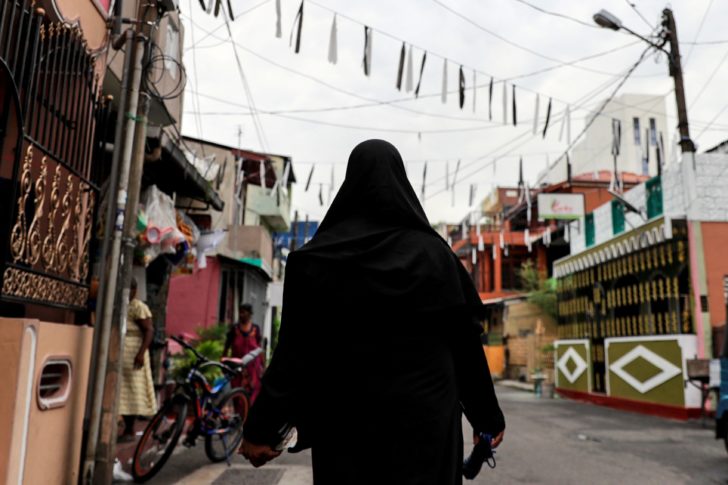 A Muslim woman wearing a hijab walks through a street near St Anthony's Shrine in Colombo