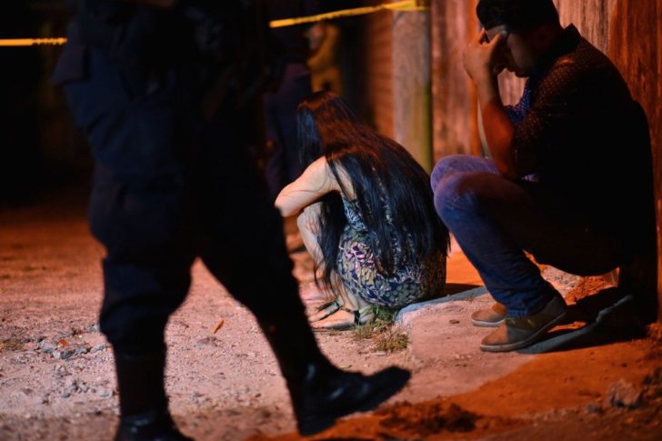 Relatives and friends mourn outside the bar where 13 people were killed in a shooting, in Minatitlan, Mexico on April 19, 2019. Photo: AFP