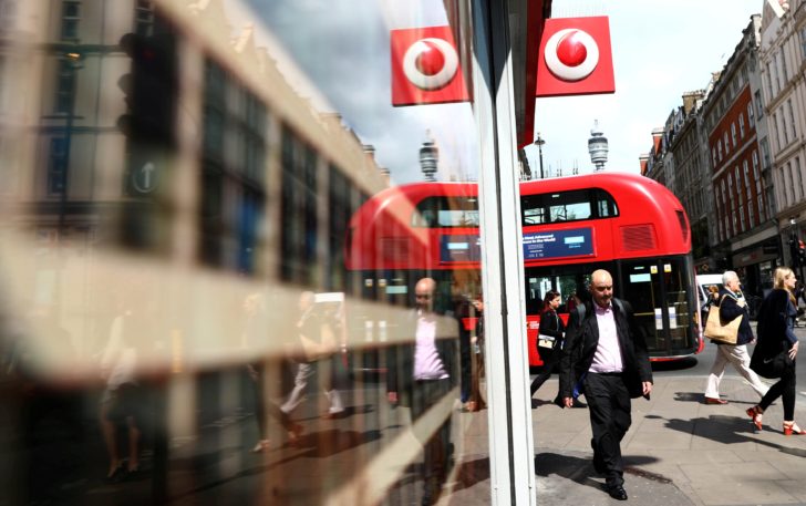 FILE PHOTO: A branded sign is displayed on a Vodafone store in London
