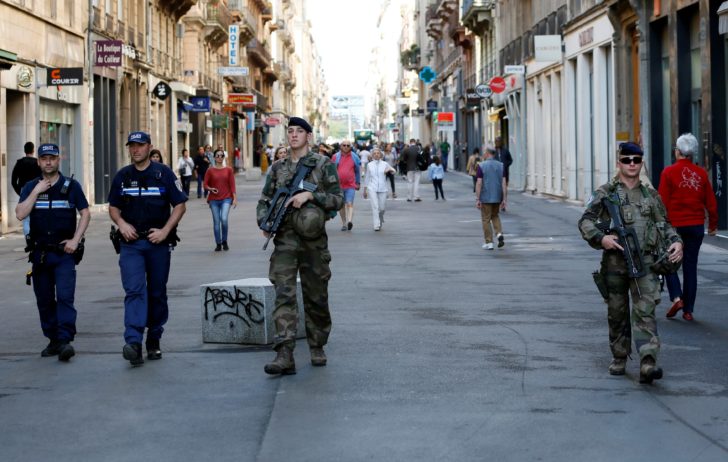 Police and army patrol the streets during the manhunt of a suspected suitcase bomber in central Lyon