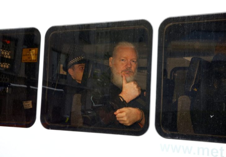 FILE PHOTO: WikiLeaks founder Julian Assange is seen in a police van after was arrested by British police outside the Ecuadorian embassy in London