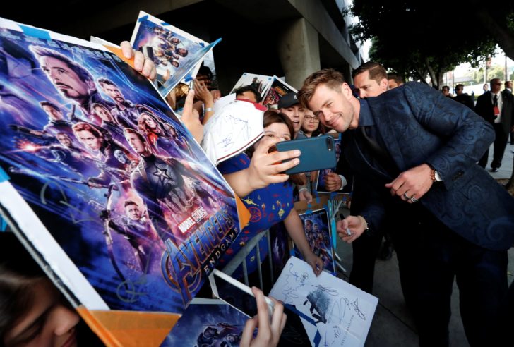 Cast member Chris Hemsworth poses with fans on the red carpet at the world premiere of the film