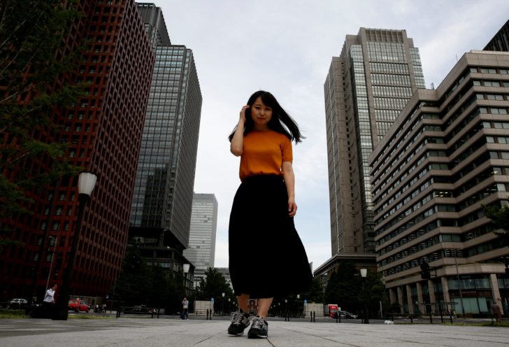 Yumi Ishikawa poses in a business district during an interview with Reuters in Tokyo