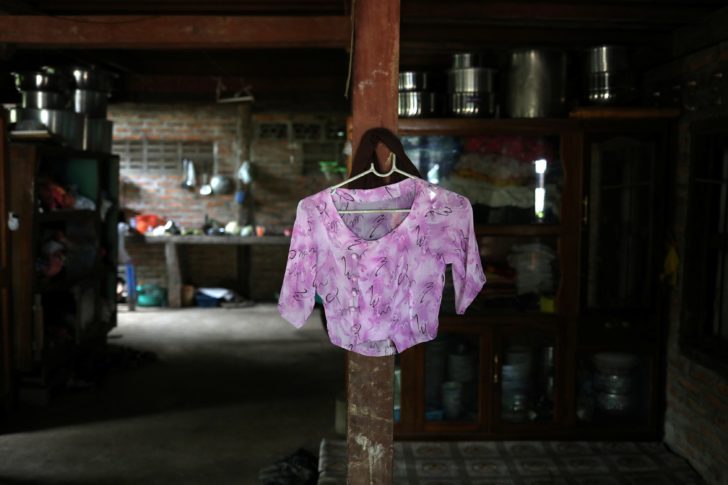 A blouse belonging to Kyu Kyu Win, who says she is going through a divorce with an abusive husband, hangs on a shelf at a house in Dawei