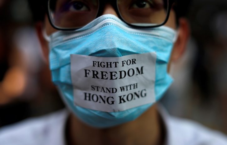 Masked anti-government protesters gather in Central Hong Kong
