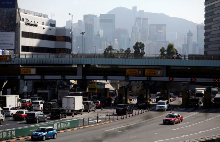 Cars drive past the toll booth area of the re-opened Cross-Harbor Tunnel in Hong Kong