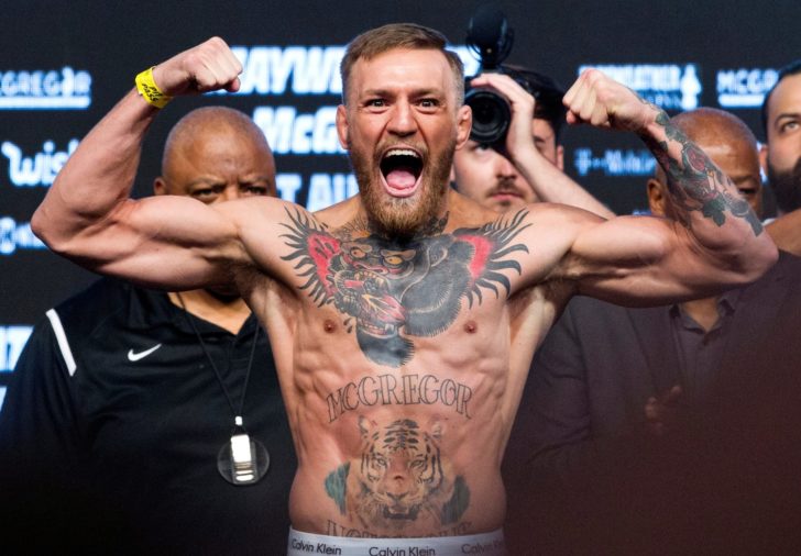 FILE PHOTO: UFC lightweight champion Conor McGregor of Ireland poses on the scale during his official weigh-in at T-Mobile Arena in Las Vegas