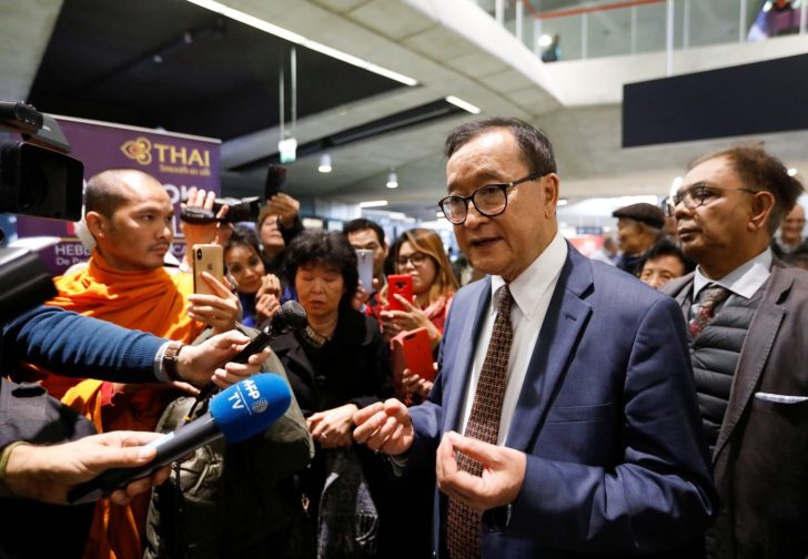 Cambodia's self-exiled opposition party founder Sam Rainsy, who has vowed to return to his home country, talks to supporters after being prevented from checking-in for a flight from Paris to Bangkok at Roissy Airport in Paris