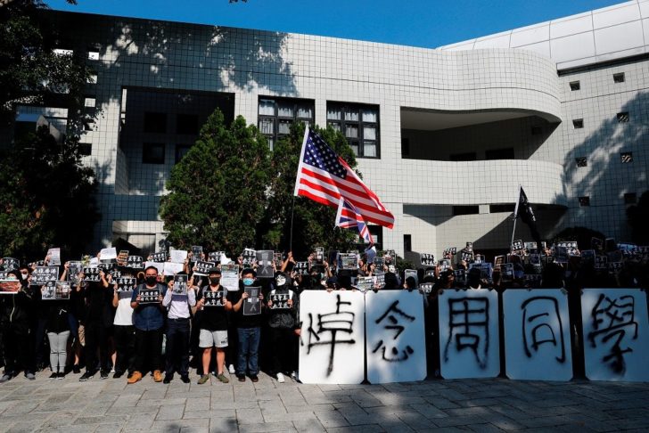 Students attend a ceremony to pay tribute to Chow Tsz-lok, 22, a university student who fell during protests at the weekend and died early on Friday morning, at the Hong Kong University of Science and Technology, in Hong Kong
