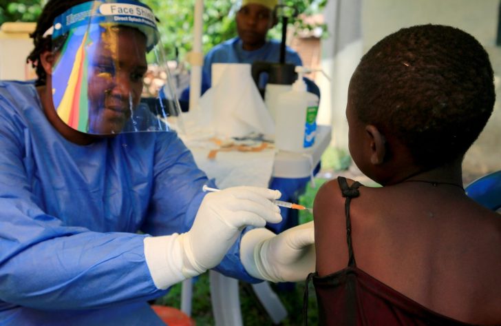 FILE PHOTO: Ugandan health worker administers Ebola vaccine to a child in Kirembo village
