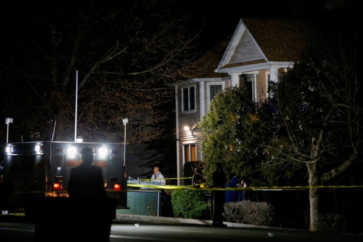 A police officer in white clothes exits the house where 5 people were stabbed at a Hasidic rabbi's home in Monsey, New York