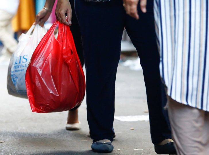 People use plastic to wrap a purchase at the market in Jakarta