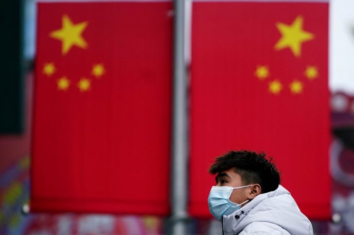 FILE PHOTO: A man wearing a mask is seen at the Nanjing Pedestrian Road, a main shopping area, in Shanghai