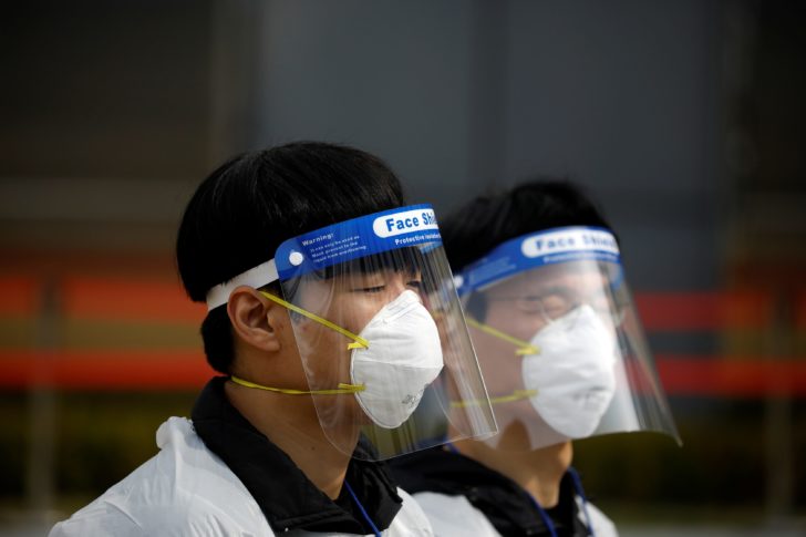 South Korean coronavirus patients cast their ballots parliamentary election at a polling station set up at a quarantine center in Yongin