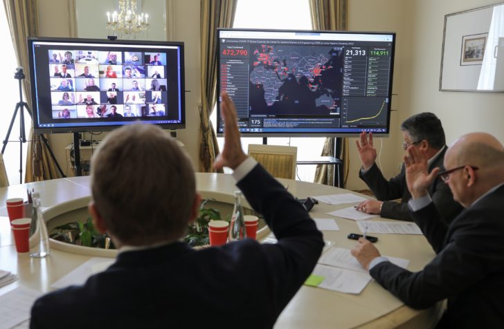 Members of the city commission to prevent the spread of coronavirus disease attend a meeting via video link in Lviv