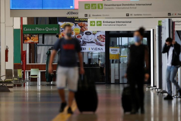 Travelers wearing protective face masks are seen at the President Juscelino Kubitschek International Airport, amid the spread of the coronavirus disease (COVID-19), in Brasilia