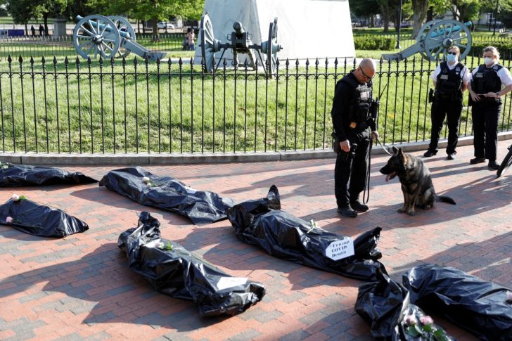 Protestors hold a funeral procession demonstration for the coronavirus disease (COVID-19) victims outside of the White House in Washington