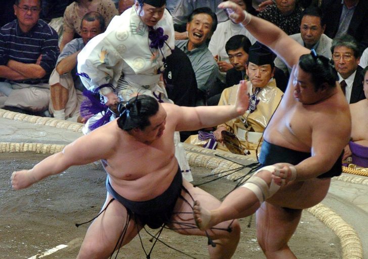 FILE PHOTO: Asashoryu Akinori pushes Chiyotaikai Ryuji out of the ring to win the summer grand sumo tournament with a day to spare in Tokyo