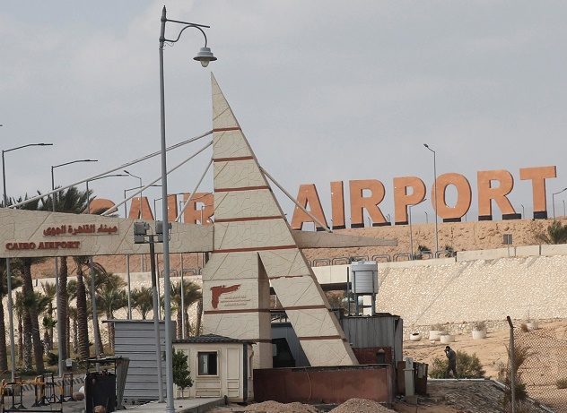FILE PHOTO: An Egyptian security member walks near the security gate of the Cairo's Internatonal Airport, following ramps up its efforts to slow the spread the coronavirus disease (COVID-19) in Cairo