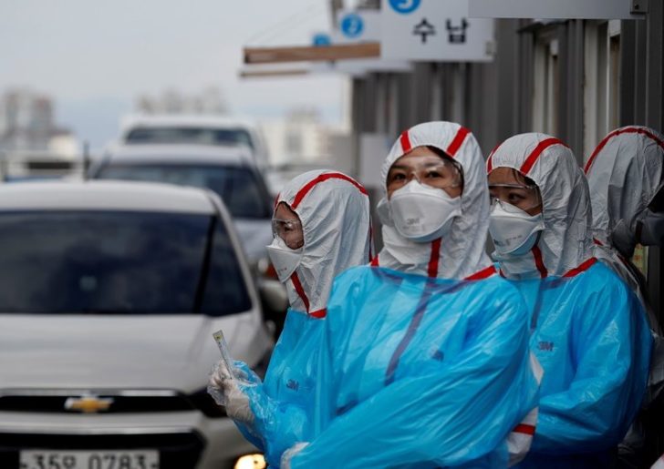 FILE PHOTO: Medical staff in protective gear work at a 'drive-thru' testing center for the novel coronavirus disease of COVID-19 in Yeungnam University Medical Center in Daegu
