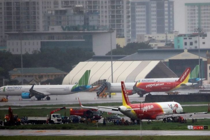 A VietJet Air passenger plane is seen on grass field after skidding at the Tan Son Nhat airport, in Ho Chi Minh city