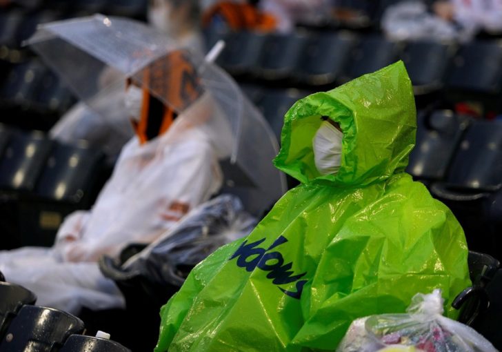 Fans wearing protective face masks wait for the start of the Nippon Professional Baseball game between Yomiuri Giants and Yakult Swallows amid the the coronavirus disease (COVID-19) outbreak in Kobe