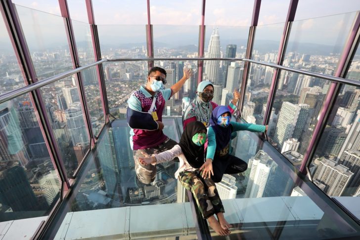 A family wearing protective face masks poses for a picture at Kuala Lumpur Tower, amid the coronavirus disease (COVID-19) outbreak, in Kuala Lumpur